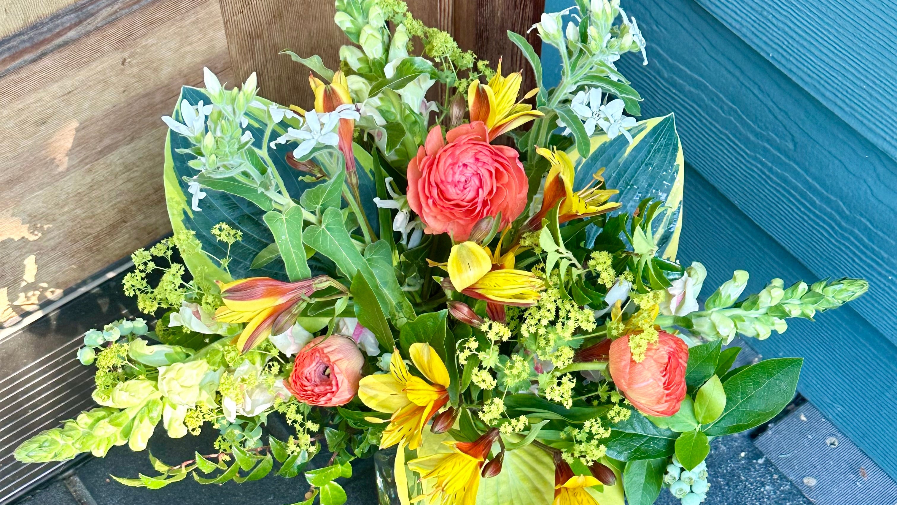 Colorful flower arrangement with ranunculus delivered to the front door